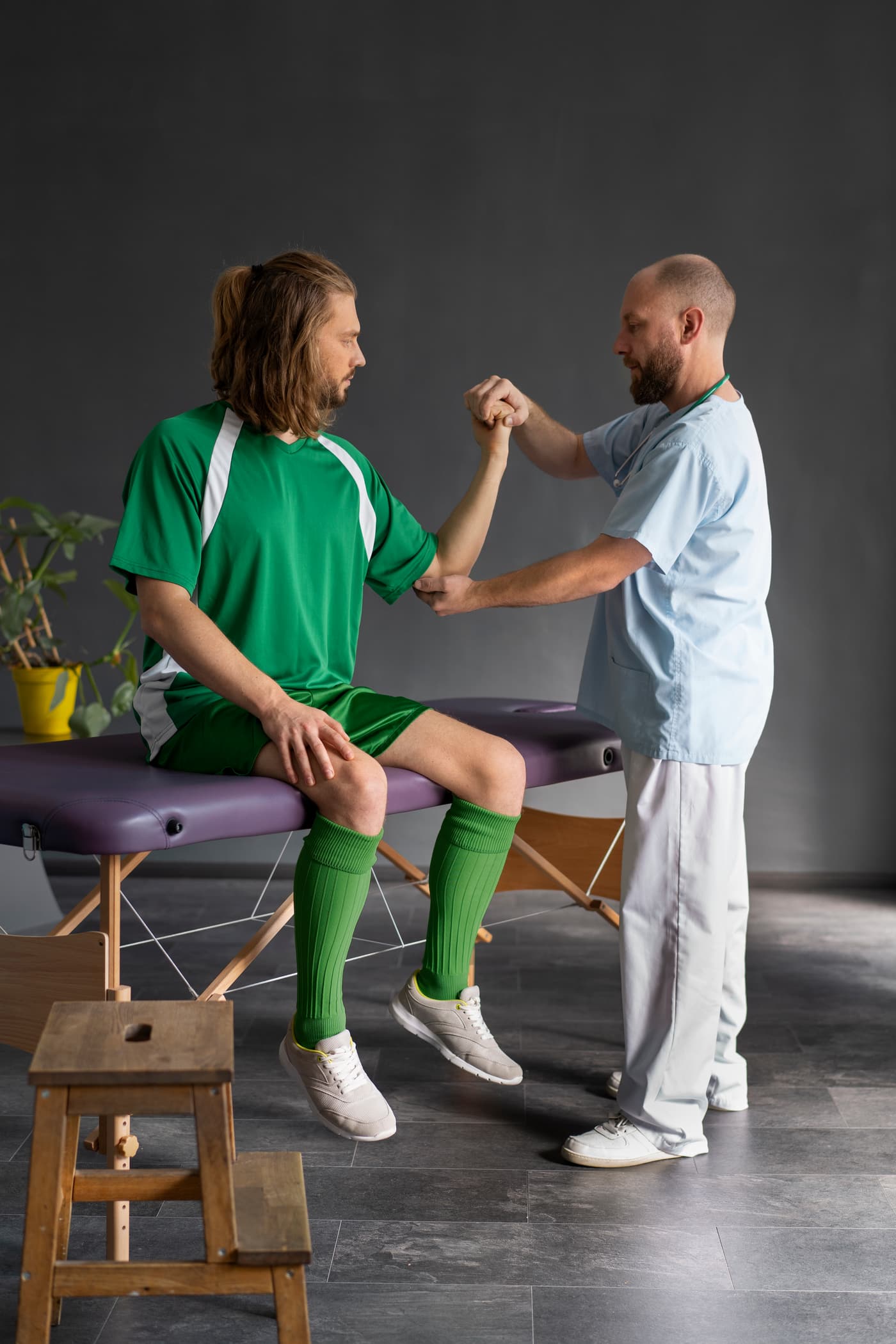 Physiotherapist assessing a patient's arm and elbow mobility