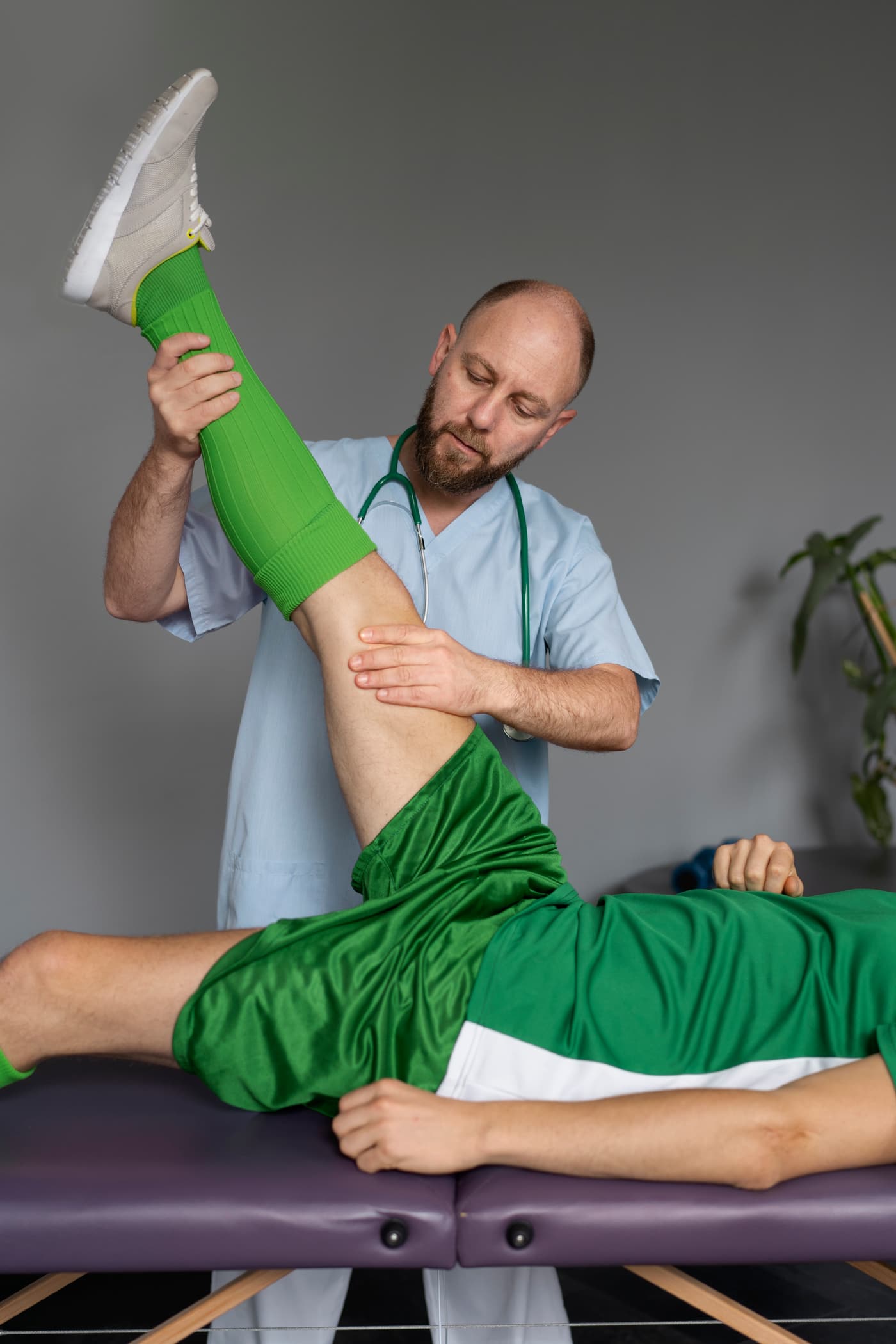 Physiotherapist guiding a patient through a hip stretch